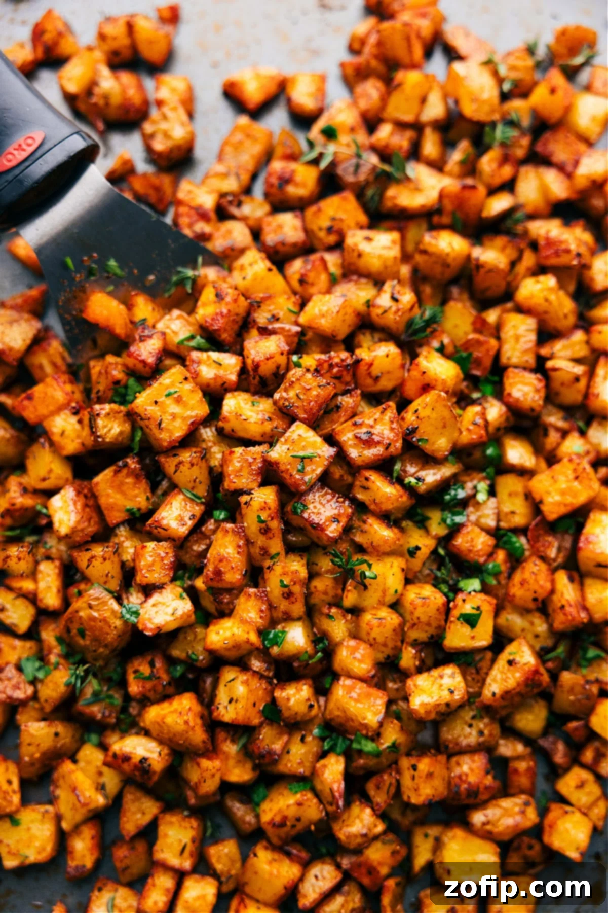 Golden brown crispy breakfast potatoes fresh out of the oven, ready to be served and enjoyed.
