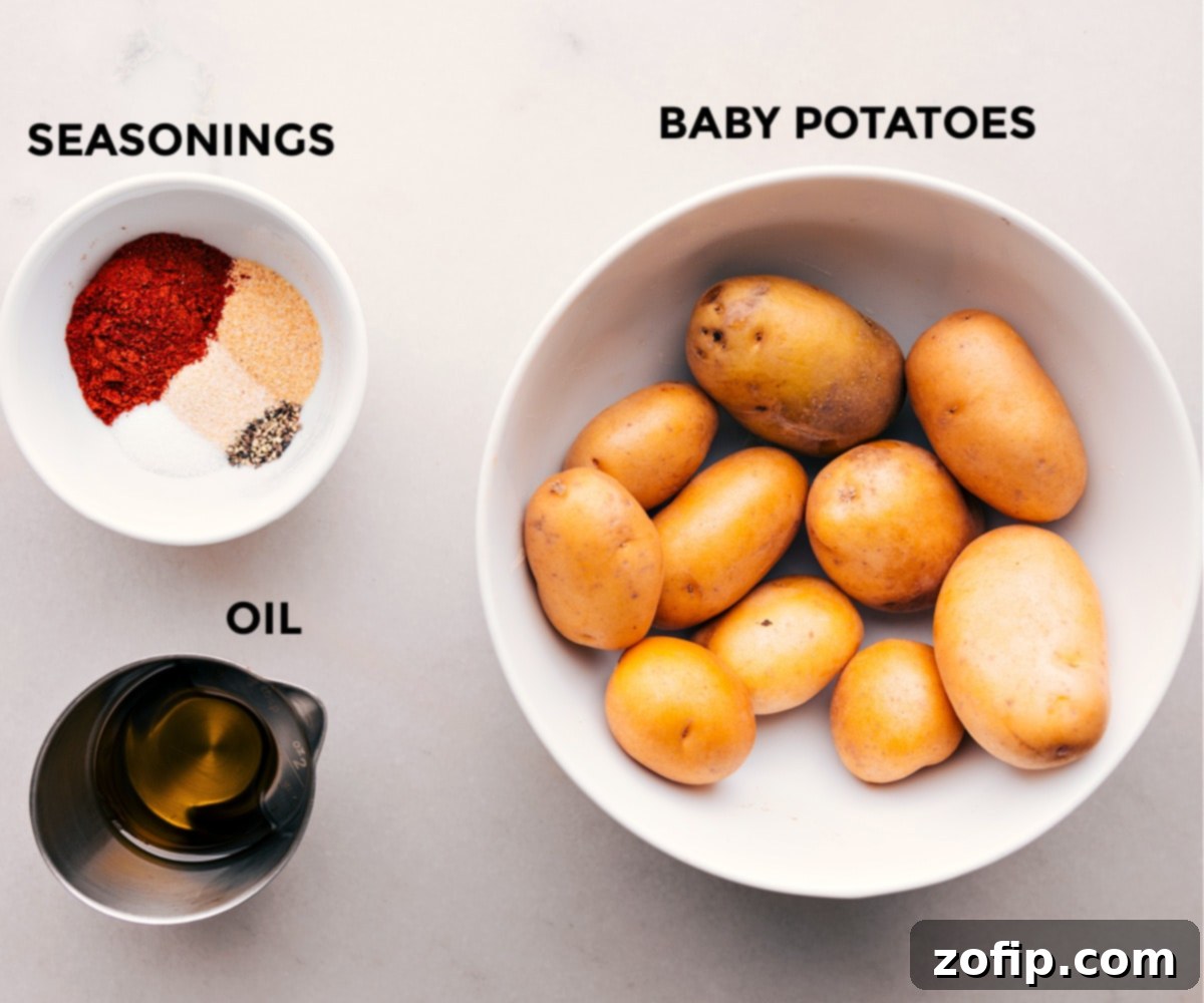 The Best Air Fryer Potatoes Ingredients A selection of fresh ingredients including baby potatoes, olive oil, and various spices, prepped and ready for making Air Fryer Potatoes.