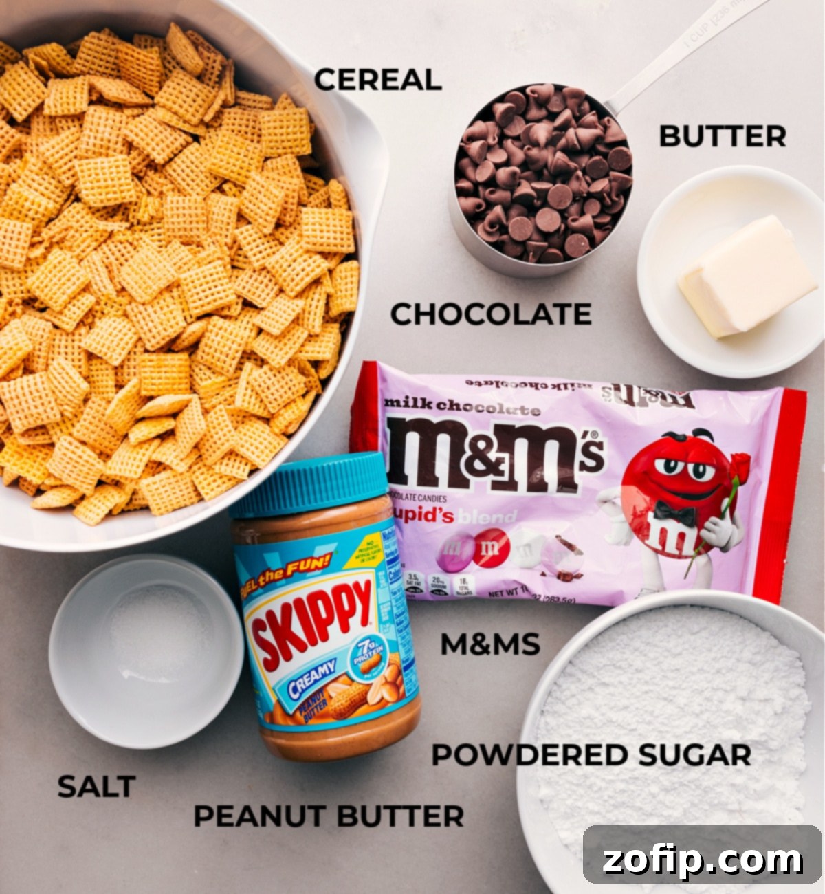 The Essential Ingredients for Valentine Snack Mix All the essential ingredients for Valentine Muddy Buddies laid out neatly on a table, ready for assembly.