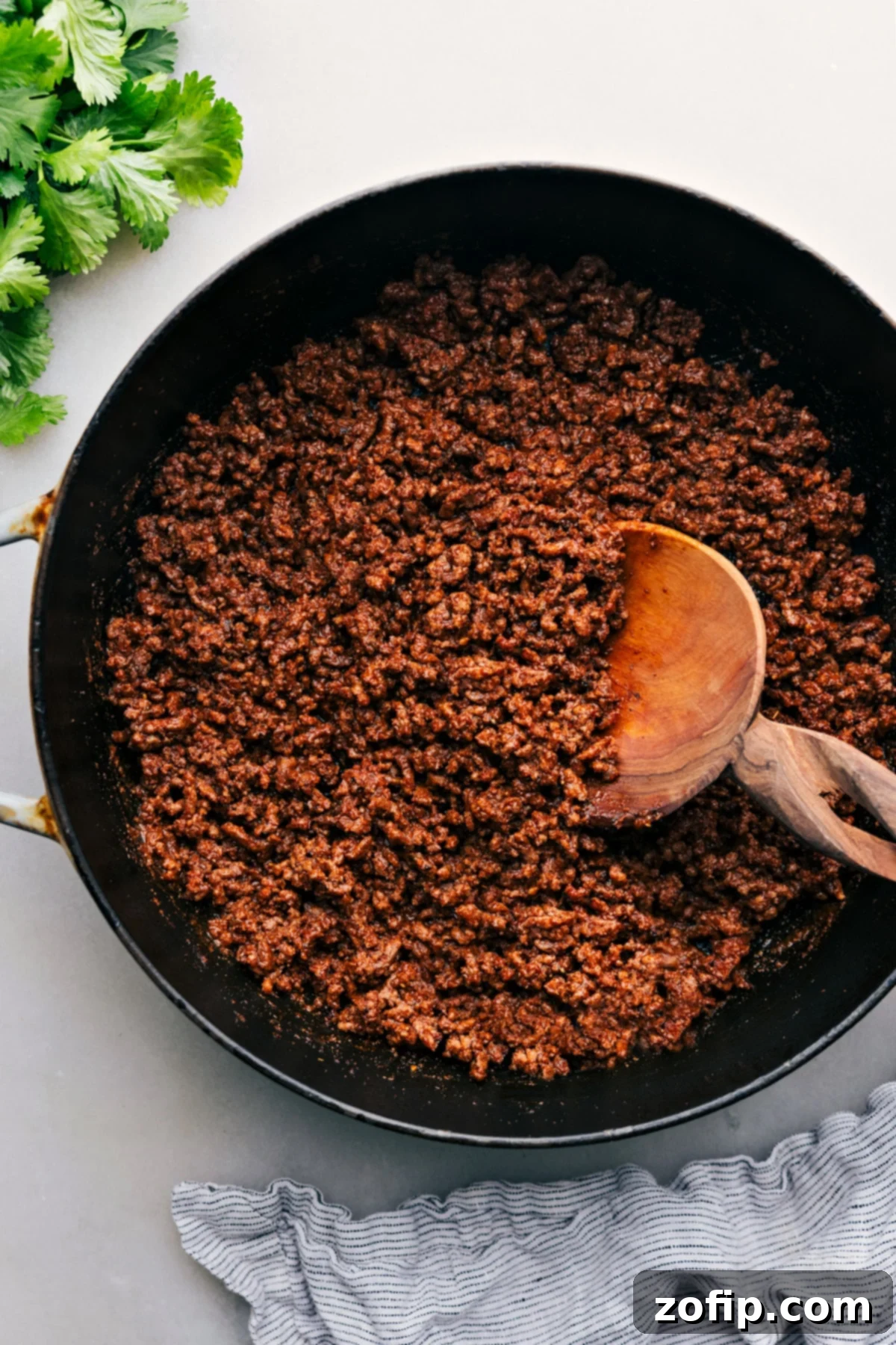 Taco Meat Recipe sizzling in a pan, ready to be served with fresh ingredients.