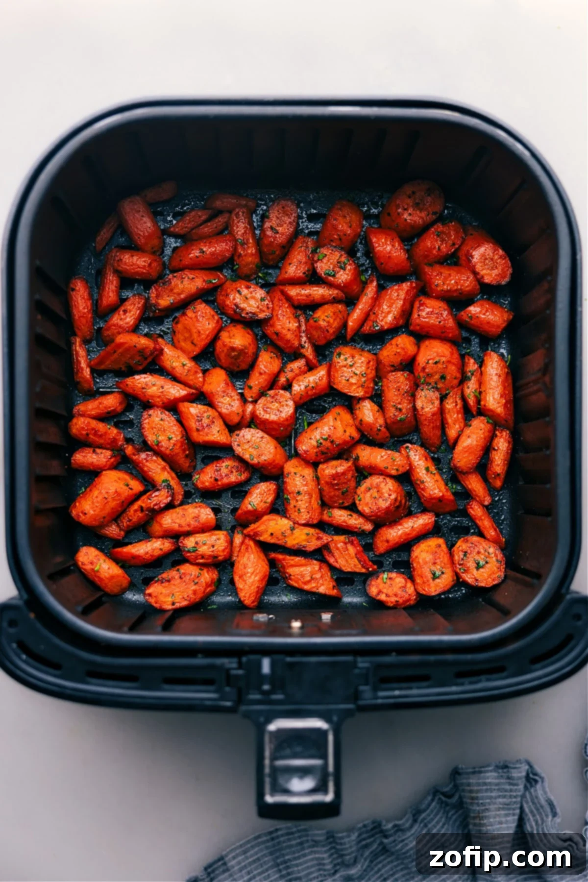 Air Fryer Carrots fresh out of the air fryer, garnished with herbs.