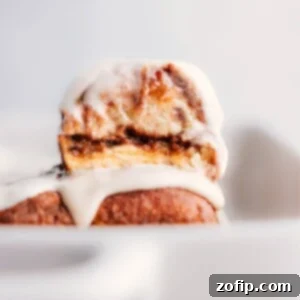 Hawaiian Roll Cinnamon Rolls stacked on top of each other, glistening with glaze.