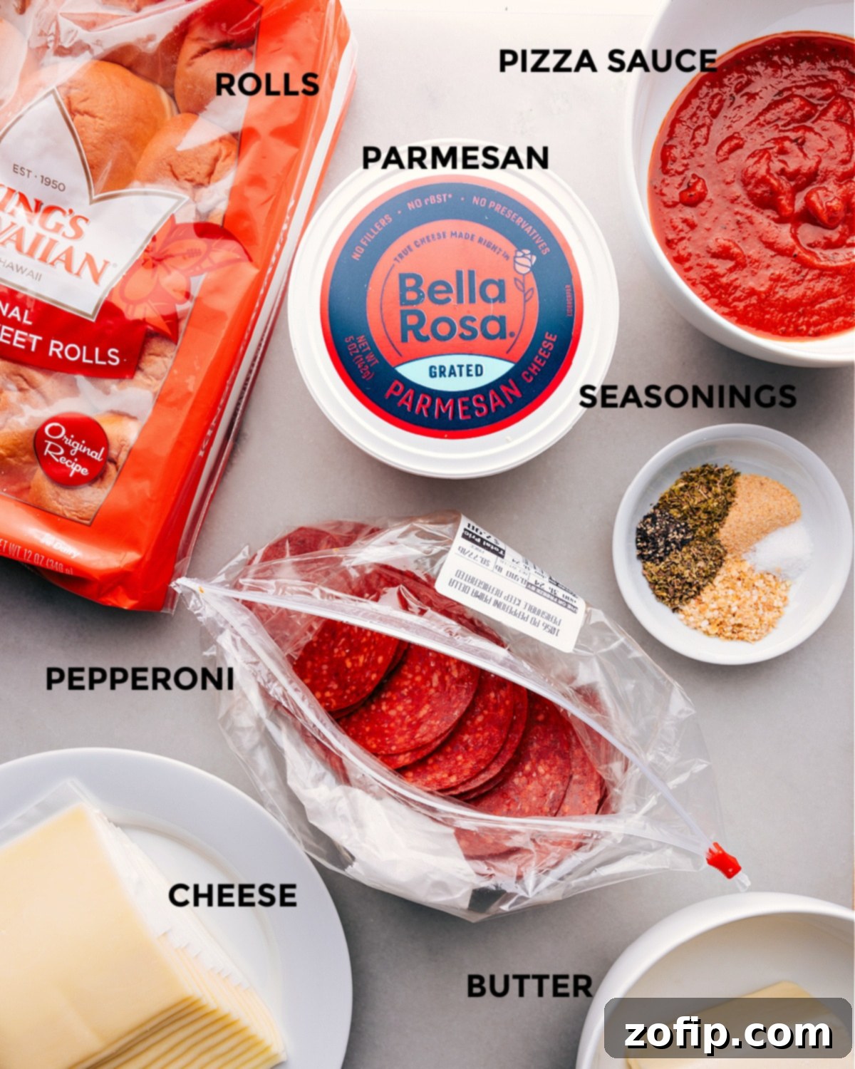 Pizza Sliders Ingredient Prep All the essential ingredients for pizza sliders laid out on a wooden surface, ready for preparation.