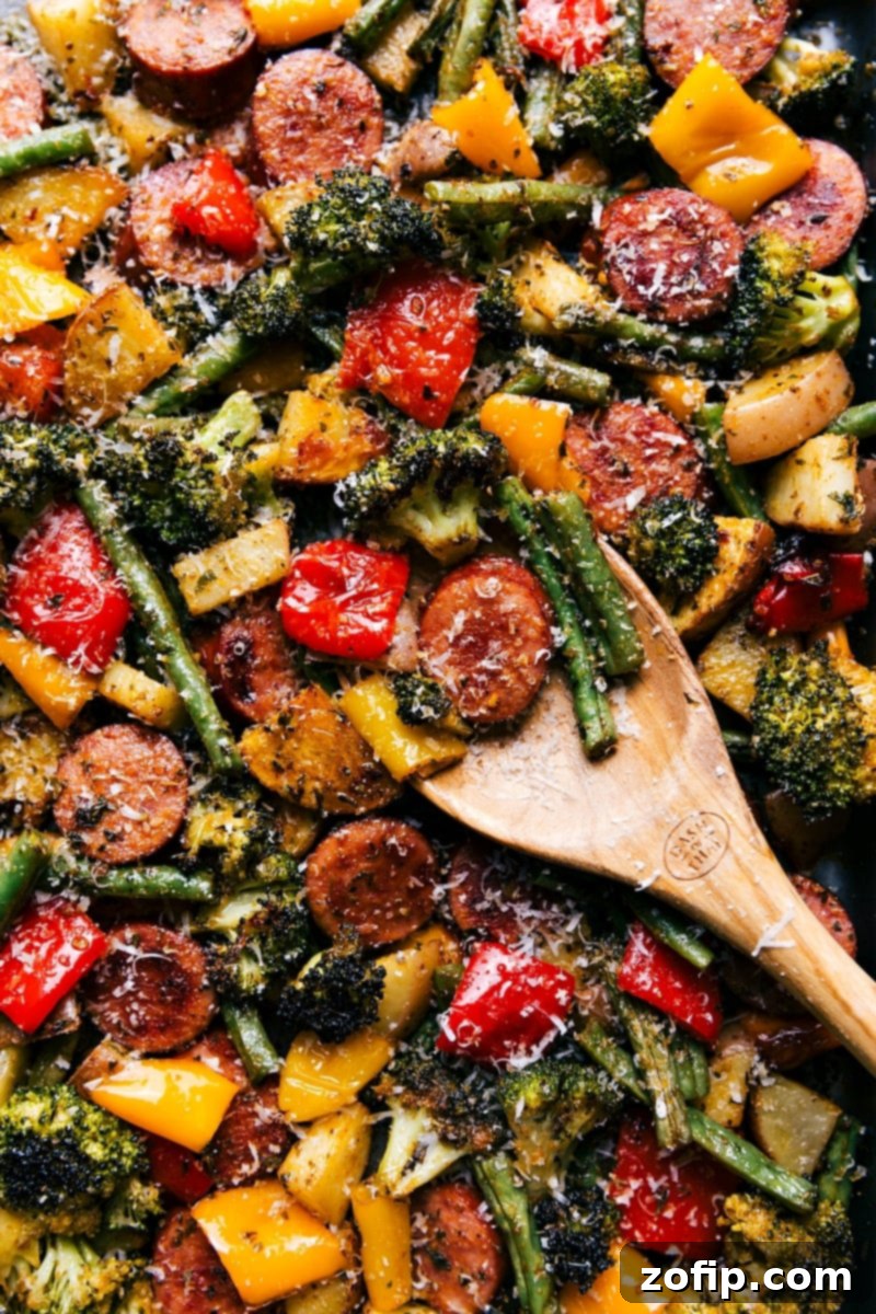 Perfectly cooked and seasoned sheet pan sausage and vegetables, ready for serving.