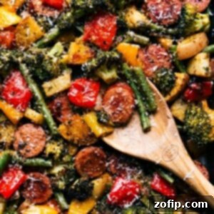 Perfectly cooked and seasoned sheet pan sausage and vegetables, ready for serving.