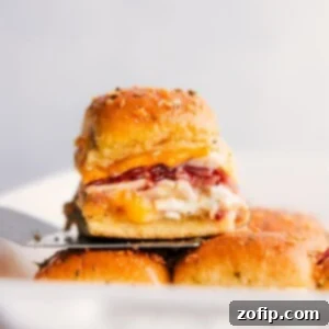 Ultimate Chicken Bacon Ranch Sliders 3 Stack of Chicken Bacon Ranch Sliders, with one sitting on a spatula.