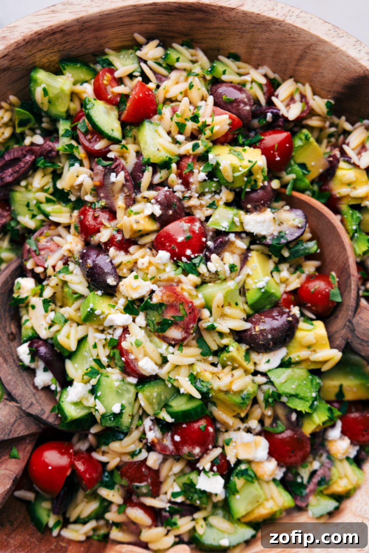 The finished Mediterranean Orzo Salad in a beautiful serving bowl, ready to be enjoyed, showcasing its vibrant colors and inviting texture.