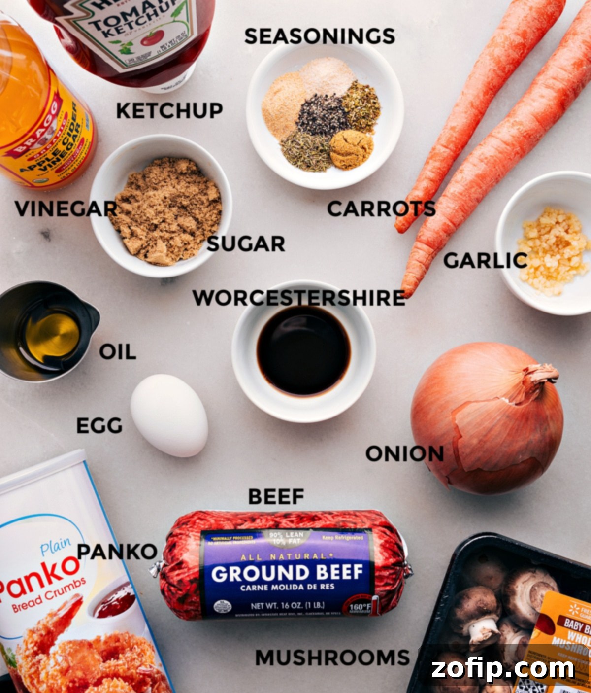 A vibrant display of fresh ingredients for the mini meatloaf recipe, including lean ground beef, panko breadcrumbs, various finely chopped vegetables, and a selection of aromatic herbs and spices, all prepped and ready for assembly.