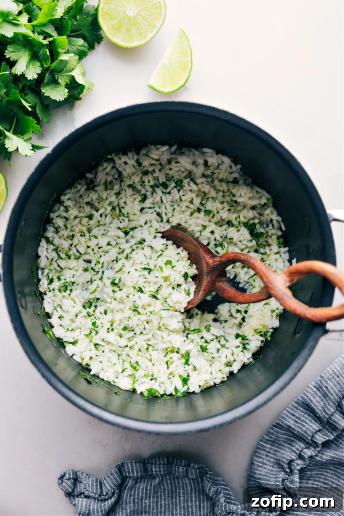 Perfect Cilantro Lime Rice Ready to Serve Cilantro-Lime Rice in a cooking pot, perfectly cooked and ready to be served, garnished with fresh cilantro sprigs.