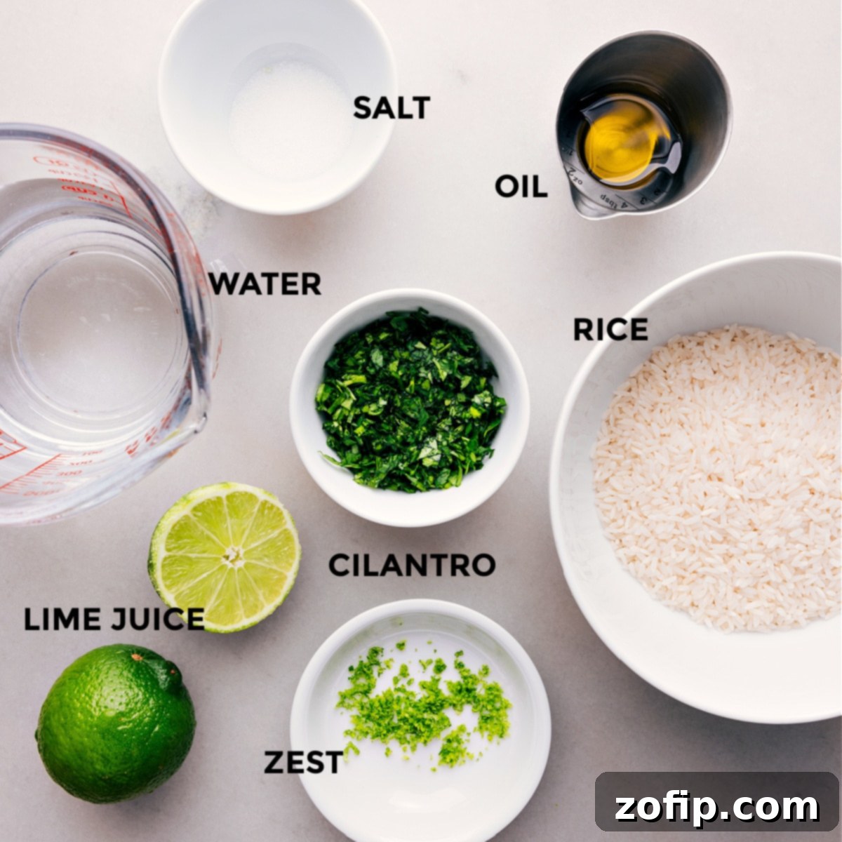 Our Favorite Cilantro-Lime Rice Ingredients All the fresh and essential ingredients used in this Cilantro-Lime Rice recipe, neatly prepped and displayed on a cutting board, ready for cooking.