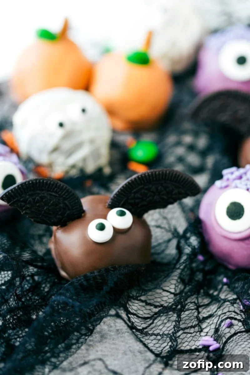 Spooky Oreo Truffles 4 Spooky Bat Oreo Balls: Dark chocolate truffles with thin Oreo cookie wings and edible eyes, ideal for Halloween parties.