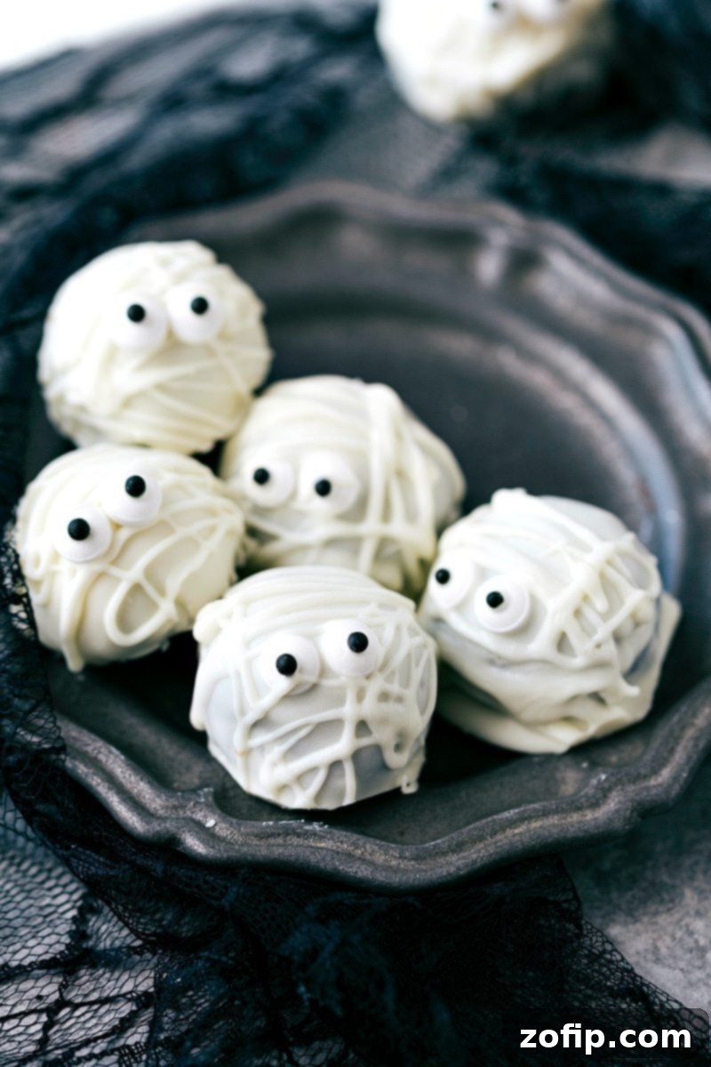 Spooky Oreo Truffles 5 Creepy Mummy Oreo Balls: White chocolate-drizzled truffles with edible eyes peeking through, a classic Halloween treat.