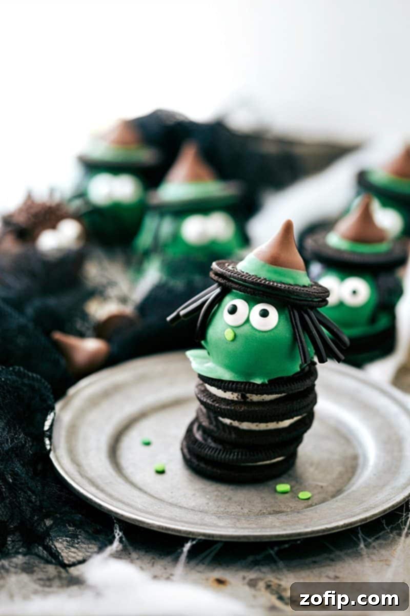 Spooky Oreo Truffles 6 Whimsical Witch Oreo Ball: A green truffle topped with a witch's hat, licorice hair, and edible eyes, perfect for a Halloween party.