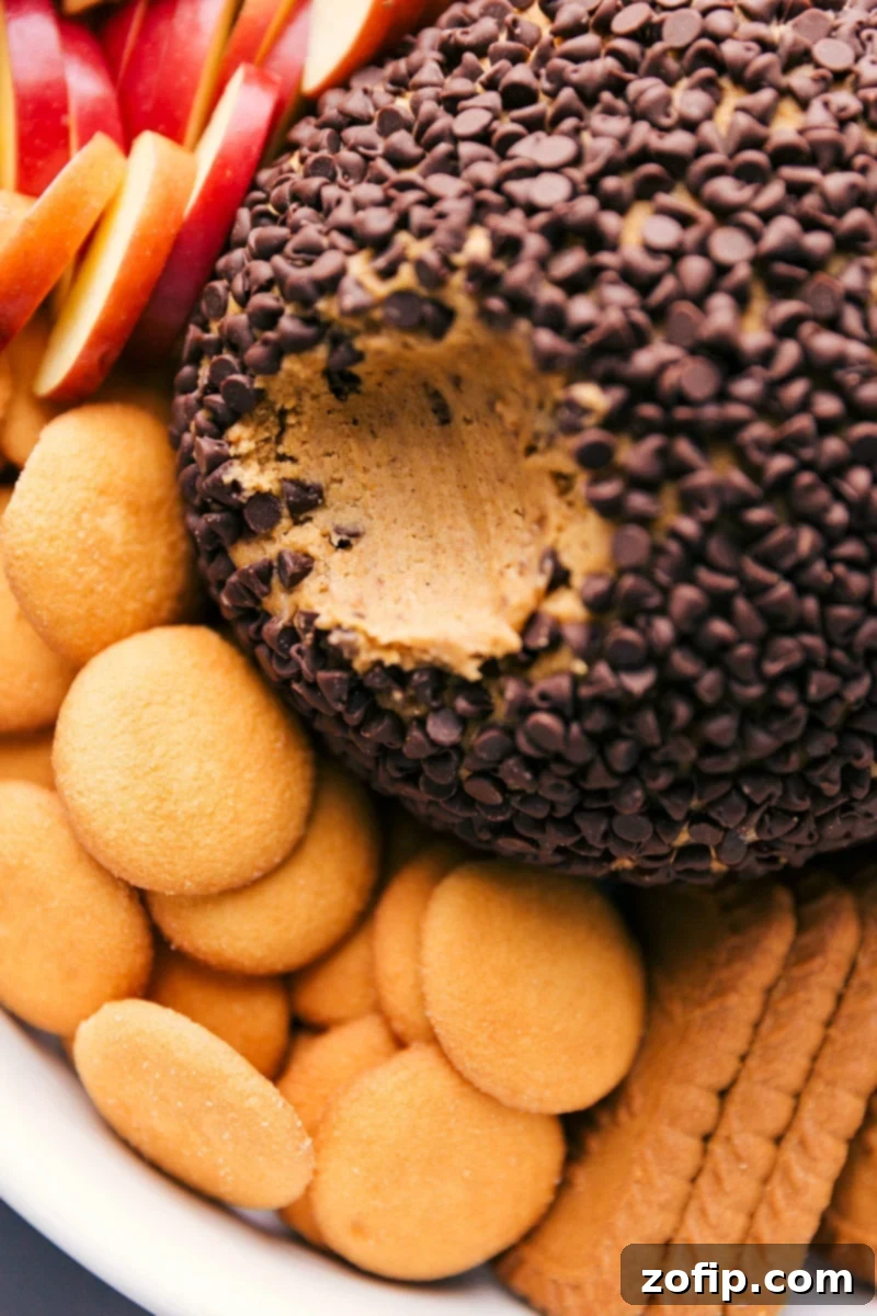 Pumpkin Cheesecake Ball with Smooth Interior The finished no-bake pumpkin cheesecake ball, cut open to reveal its smooth, creamy, and enticing interior texture, ready to be enjoyed as an irresistible dessert.