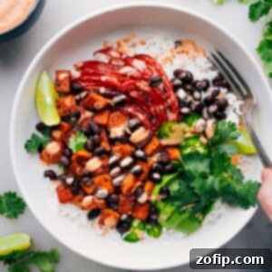 Sweet Potato & Black Bean Burrito Bowls with dressing drizzled over it.