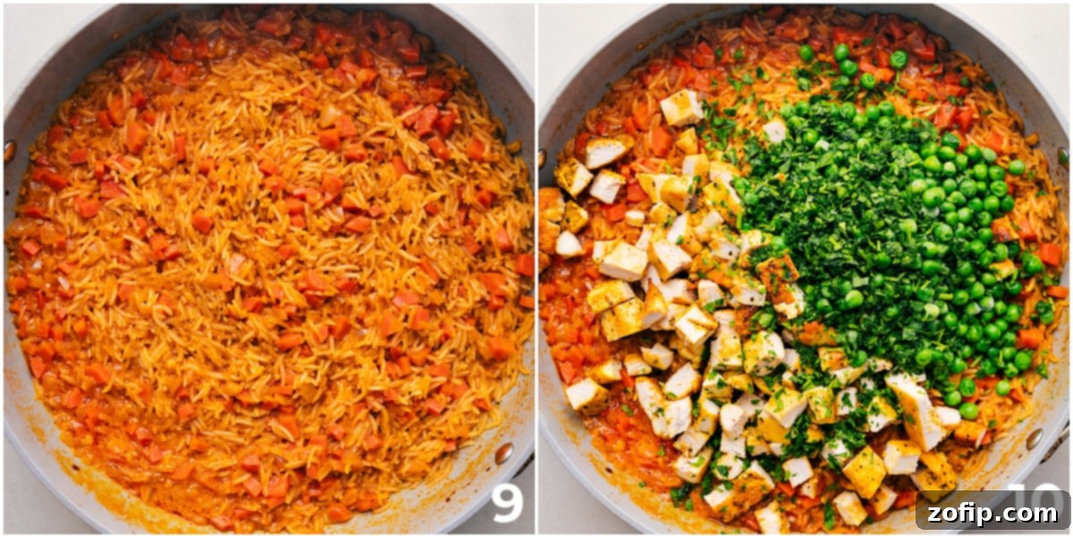 Diced cooked chicken, fresh herbs, and frozen peas being stirred into the finished One Pot Coconut Curry Chicken and Rice in the pot, ready to serve.