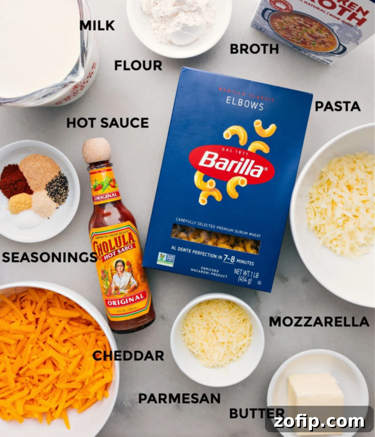 All the fresh ingredients laid out and prepped for cooking the one-pot Mac and Cheese, including various cheeses, pasta, and seasonings.