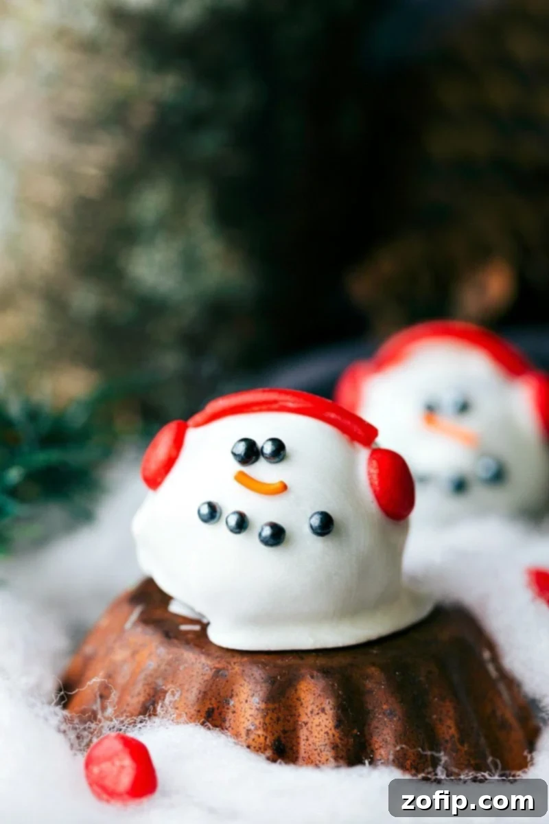 Five different ways to dress up an OREO Cookie truffle for Christmas -- Santa's hat, Reindeer, Ornament, Snowman, and Christmas hearts. Image of the snowman Oreo truffle, perfect for a winter wonderland treat