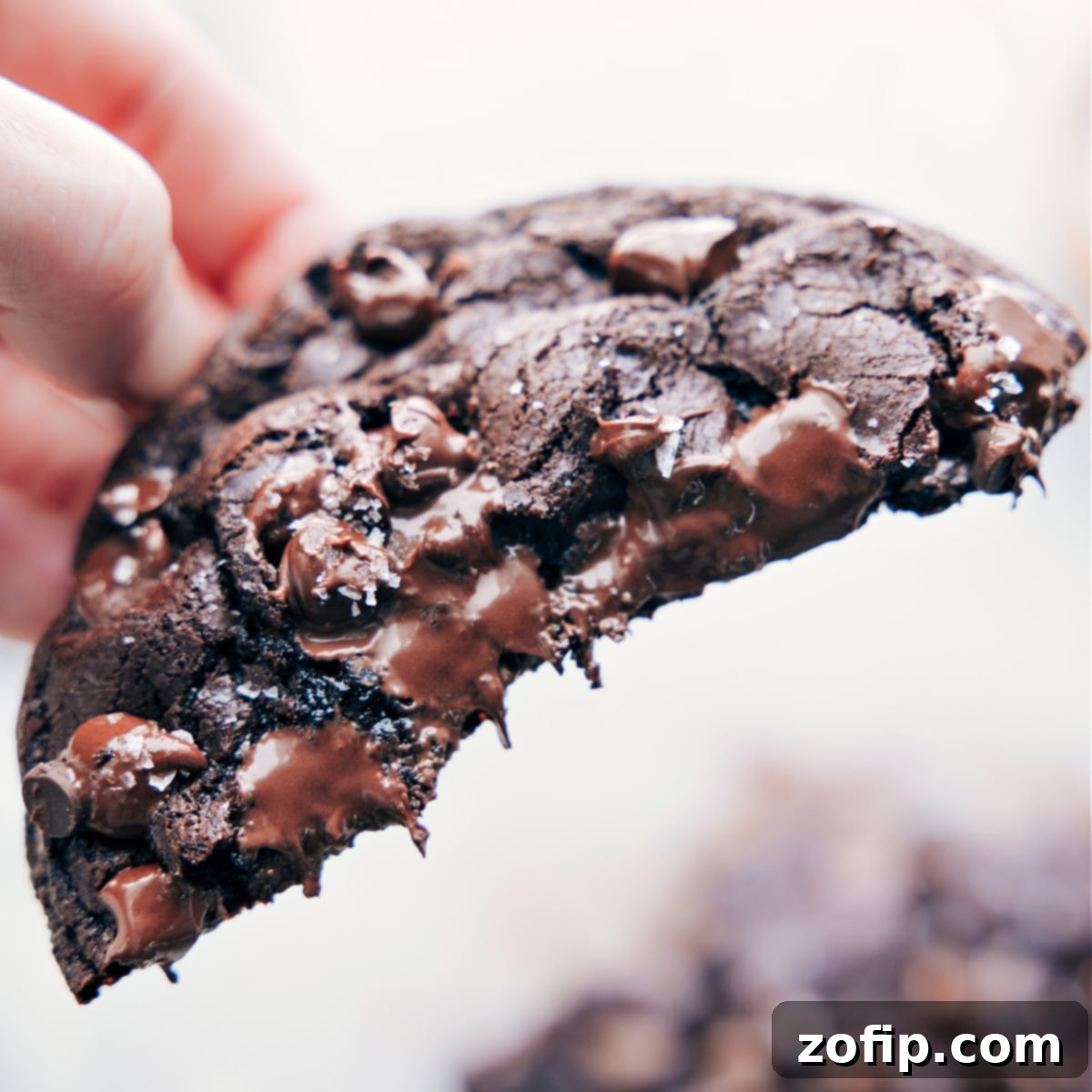 Double Chocolate Single Serve Cookies Half of the dessert held up showing the gooey center.