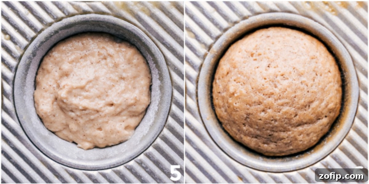 A close-up shot of baked applesauce muffins cooling on a wire rack, highlighting their perfectly domed, fluffy texture and golden-brown cinnamon-sugar tops.