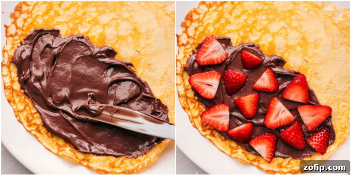 Spreading Nutella on freshly made crepes and generously topping them with sliced strawberries.