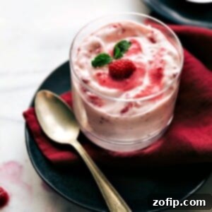 A top-down view of the vibrant Raspberry Fluff, elegantly presented in a serving dish, highlighting its delightful fluffy texture and rich pink color, ready to be enjoyed.