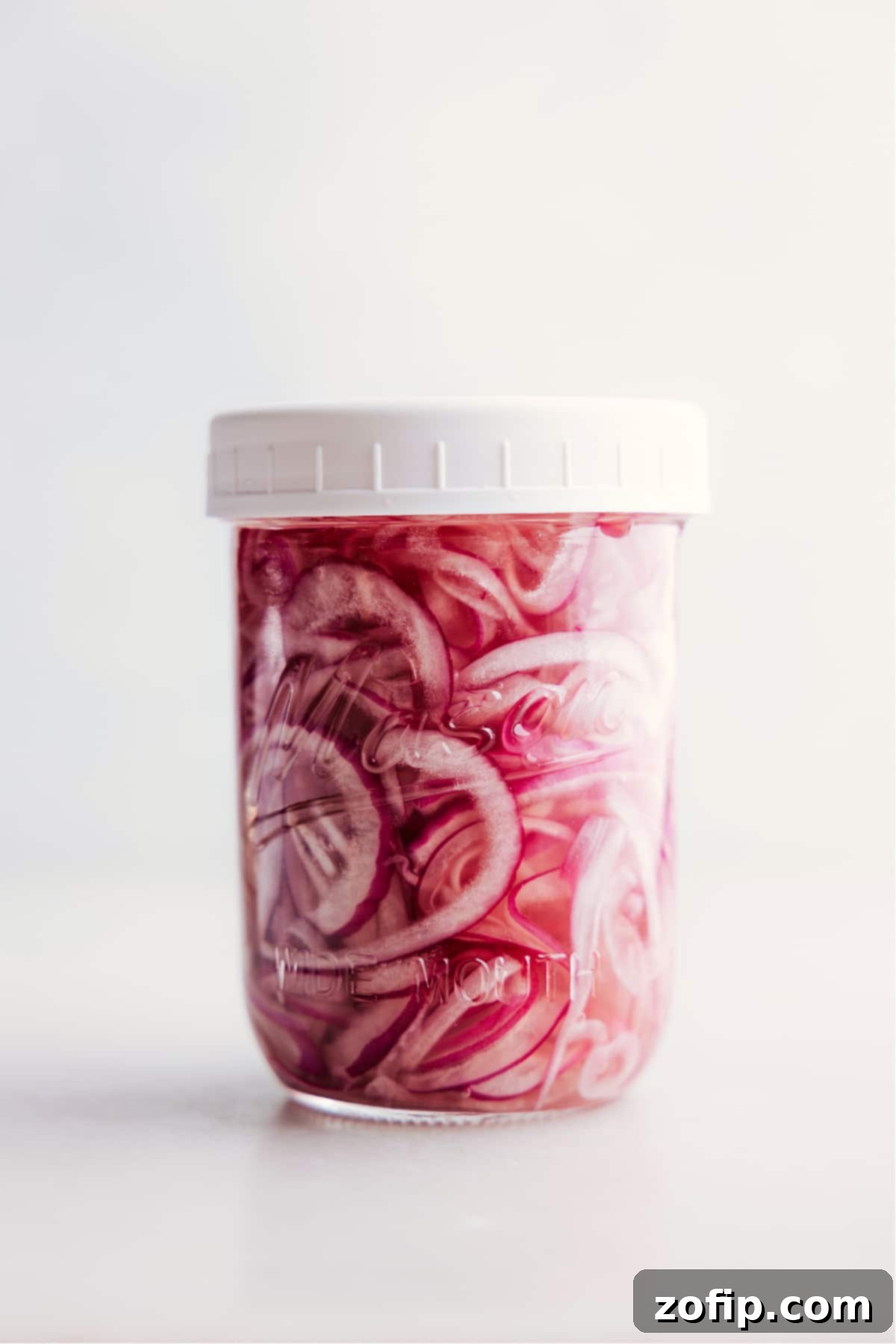 Easy Homemade Pickled Red Onions A jar of freshly made pickled red onions, ready to be enjoyed.
