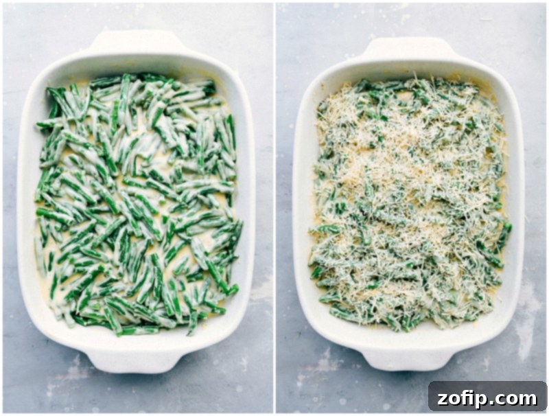 Generous amount of freshly shredded cheese being sprinkled over a bed of green beans and creamy sauce in a casserole dish.