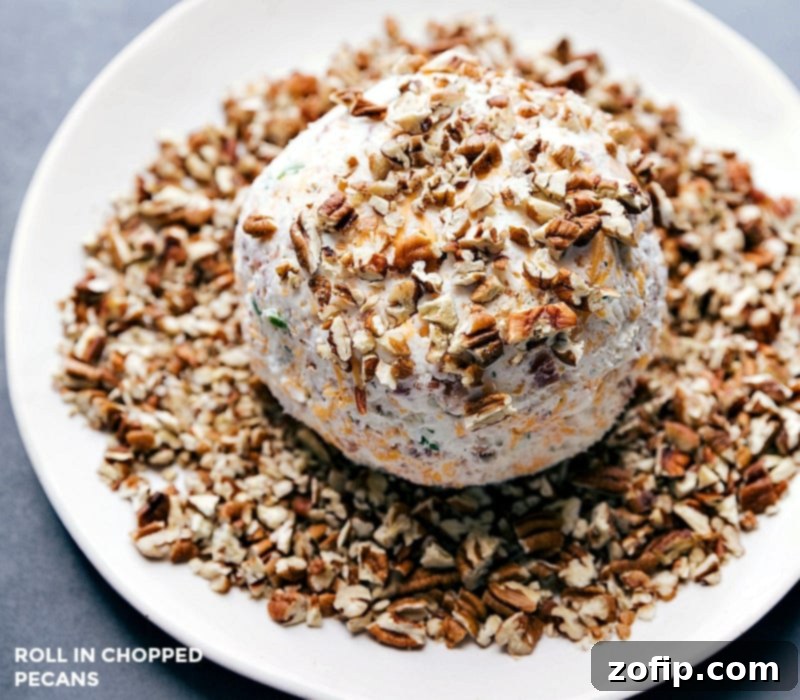 Rolling the cheese ball in chopped pecans to make the already delicious snack even more beautiful and add a crunchy texture.