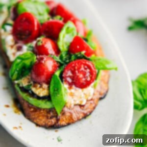A beautifully plated Caprese Cottage Cheese Toast, vibrant with fresh toppings and ready to be served as a delightful meal.