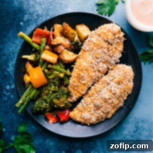 Golden Crispy Parmesan Chicken Tenders 2 Crispy Baked Parmesan Chicken Tenders with roasted vegetables.