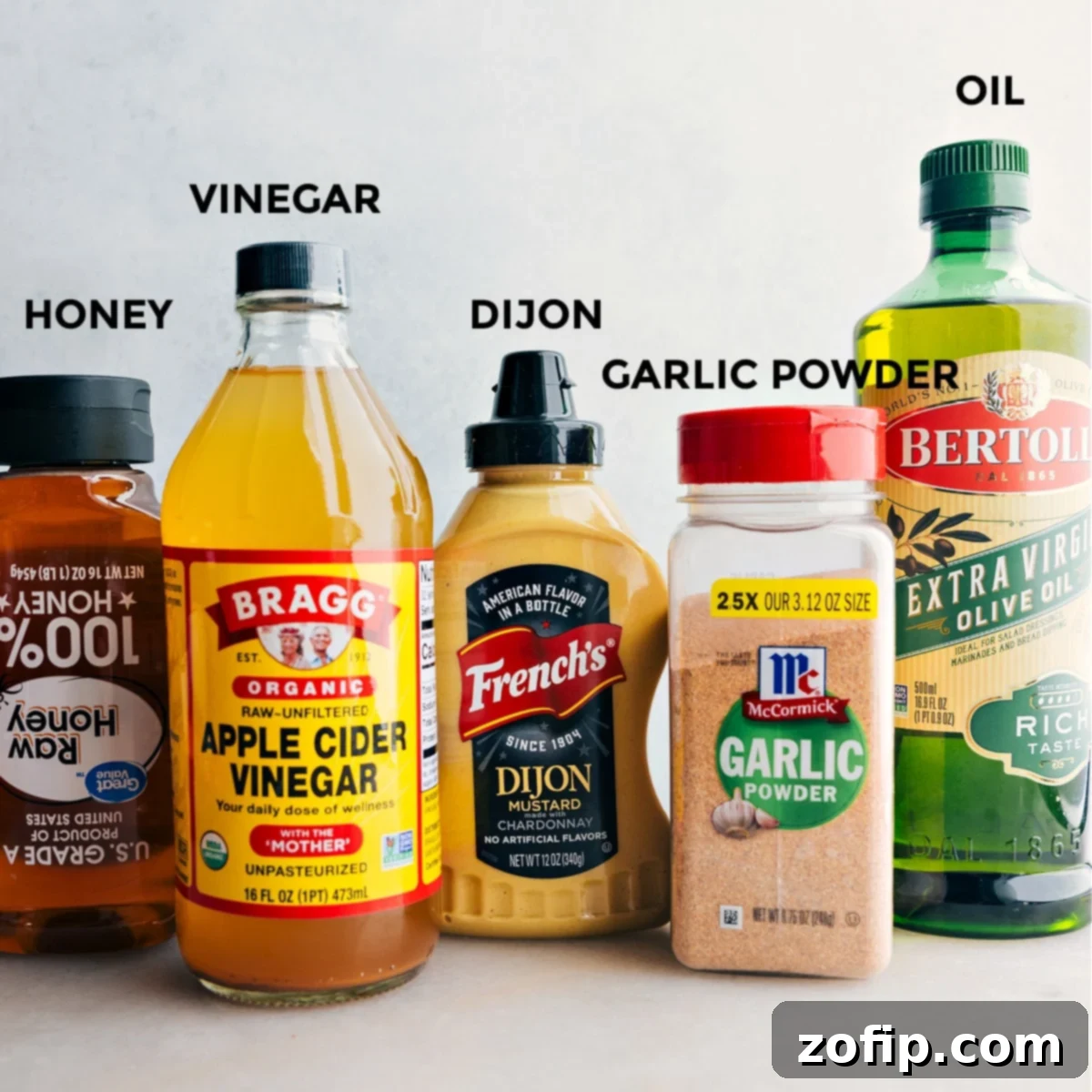 All the vibrant ingredients for the Chick-fil-A Kale Salad, including the dressing components in a jar, neatly laid out on a countertop and ready to be mixed and assembled.