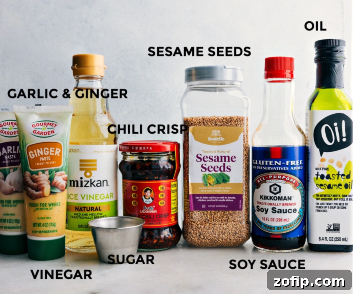 Essential Dressing Ingredients for the Best Cucumber Salad All the vibrant ingredients for the Smashed Cucumber Salad dressing laid out in small bowls, ready for mixing and assembly.