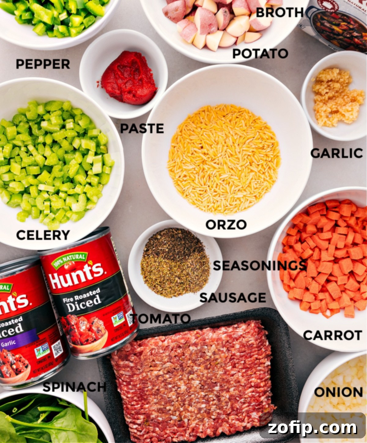 Ingredients In Italian Sausage Orzo Soup All the fresh and prepared ingredients for Italian Sausage Orzo Soup laid out, including uncooked orzo, ground sausage, chopped vegetables, broth, and seasonings.