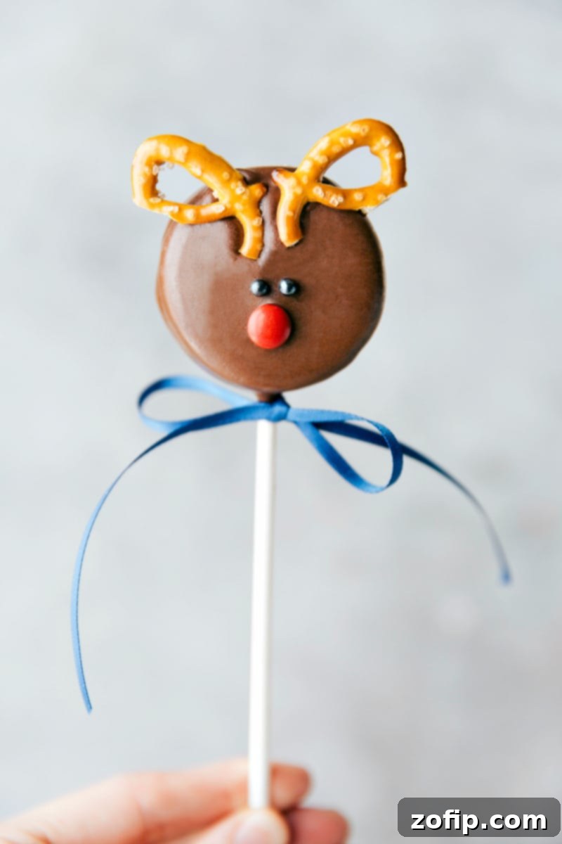 Image of a festive Rudolph Oreo Pop, complete with pretzel antlers and a red M&M nose.