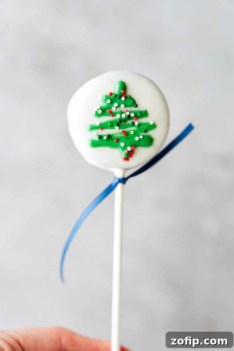Christmas Tree Oreo Pop with festive sprinkles A beautifully decorated Christmas Tree Oreo Pop adorned with colorful sprinkles.