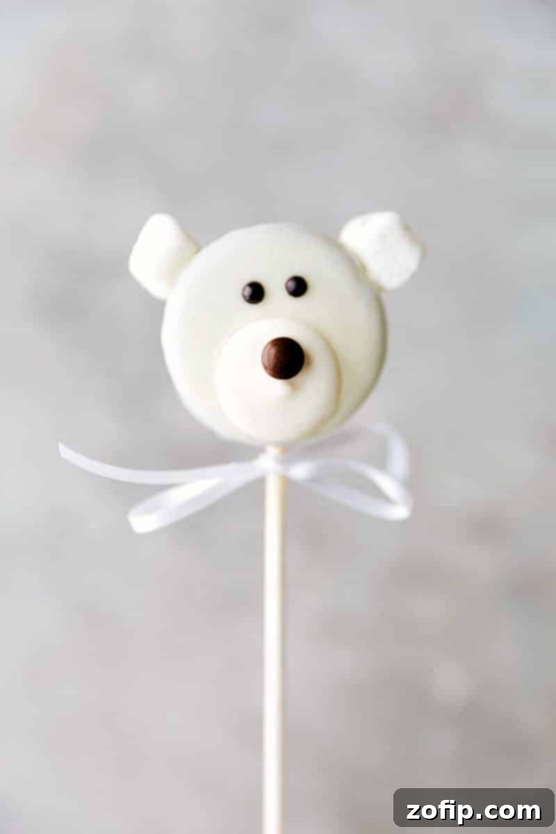 Polar Bear Oreo Pop: a cute winter treat Close-up image of an adorable Polar Bear Oreo Pop with marshmallow ears and a chocolate nose.