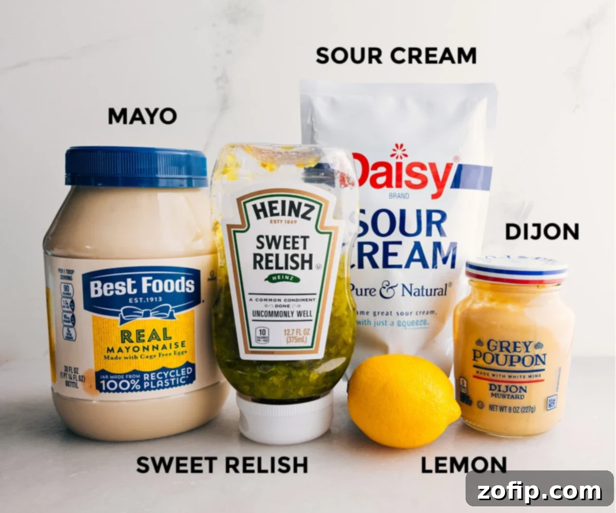 Delicious Creamy Dill Pickle Chicken Salad Sauce Preparing the creamy sauce ingredients for dill pickle chicken salad, featuring mayonnaise, sour cream, Dijon mustard, lemon juice, and seasonings.