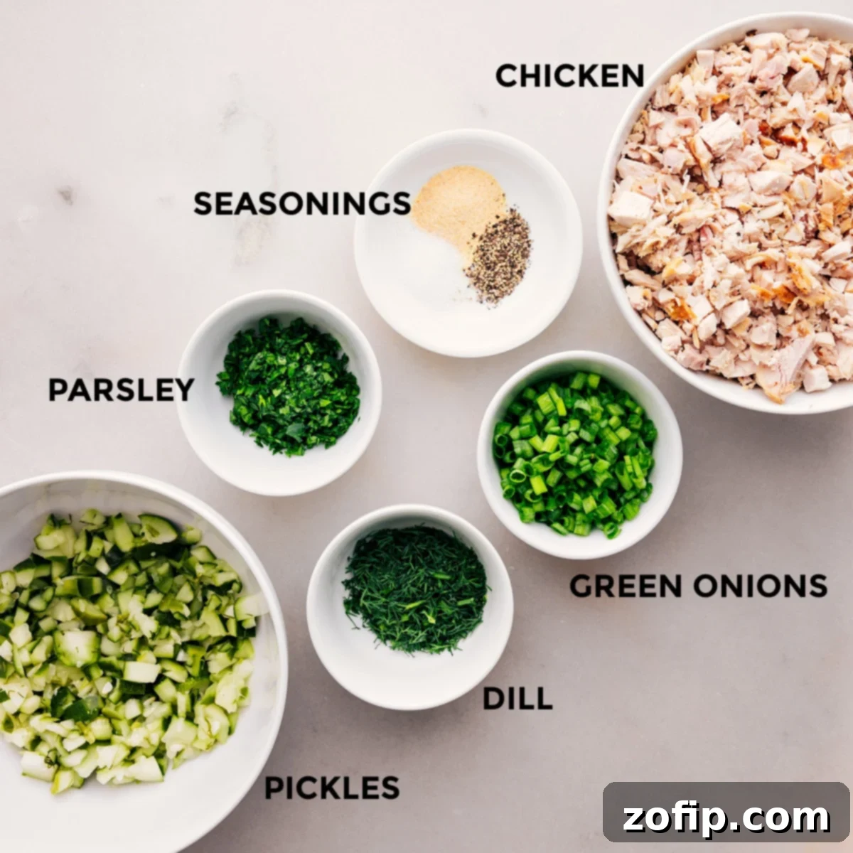 Ingredients In Dill Pickle Chicken Salad All the vibrant ingredients for dill pickle chicken salad laid out: diced chicken, finely chopped dill pickles, pickle relish, green onions, fresh parsley, and dill.