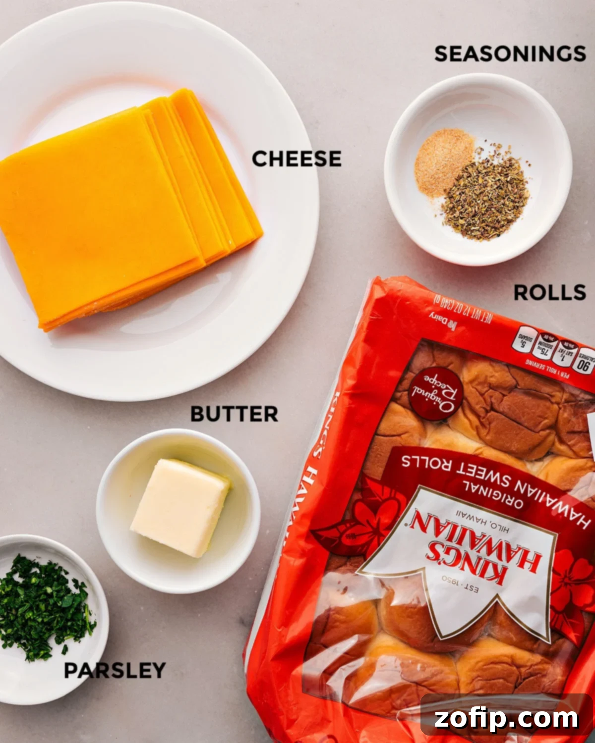 All the ingredients in this recipe are prepped for easy assembly: rolls, butter, cheese, parsley, and seasonings.