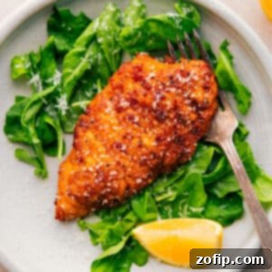 A freshly cooked chicken cutlet, perfectly golden and crispy, ready to be enjoyed.