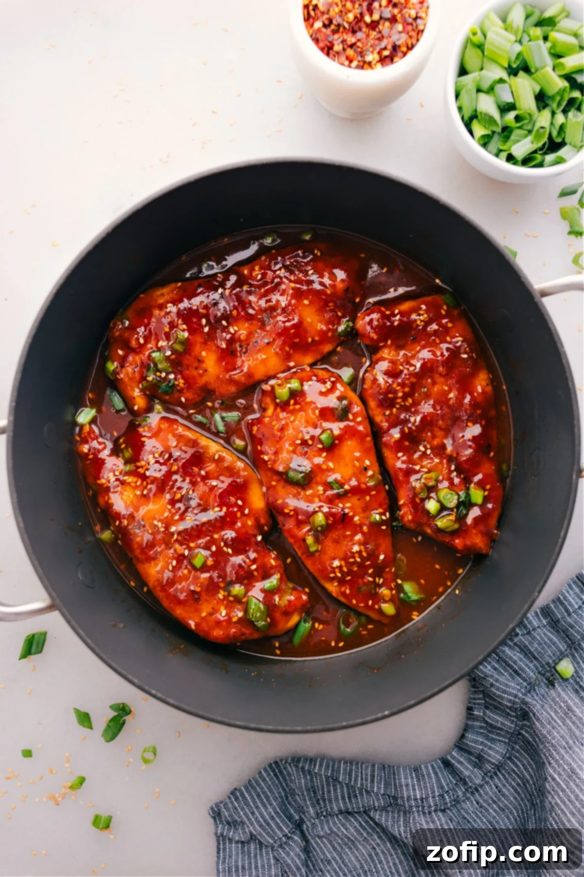 Honey Garlic Chicken cooks in a skillet and gets a topping of green onions.