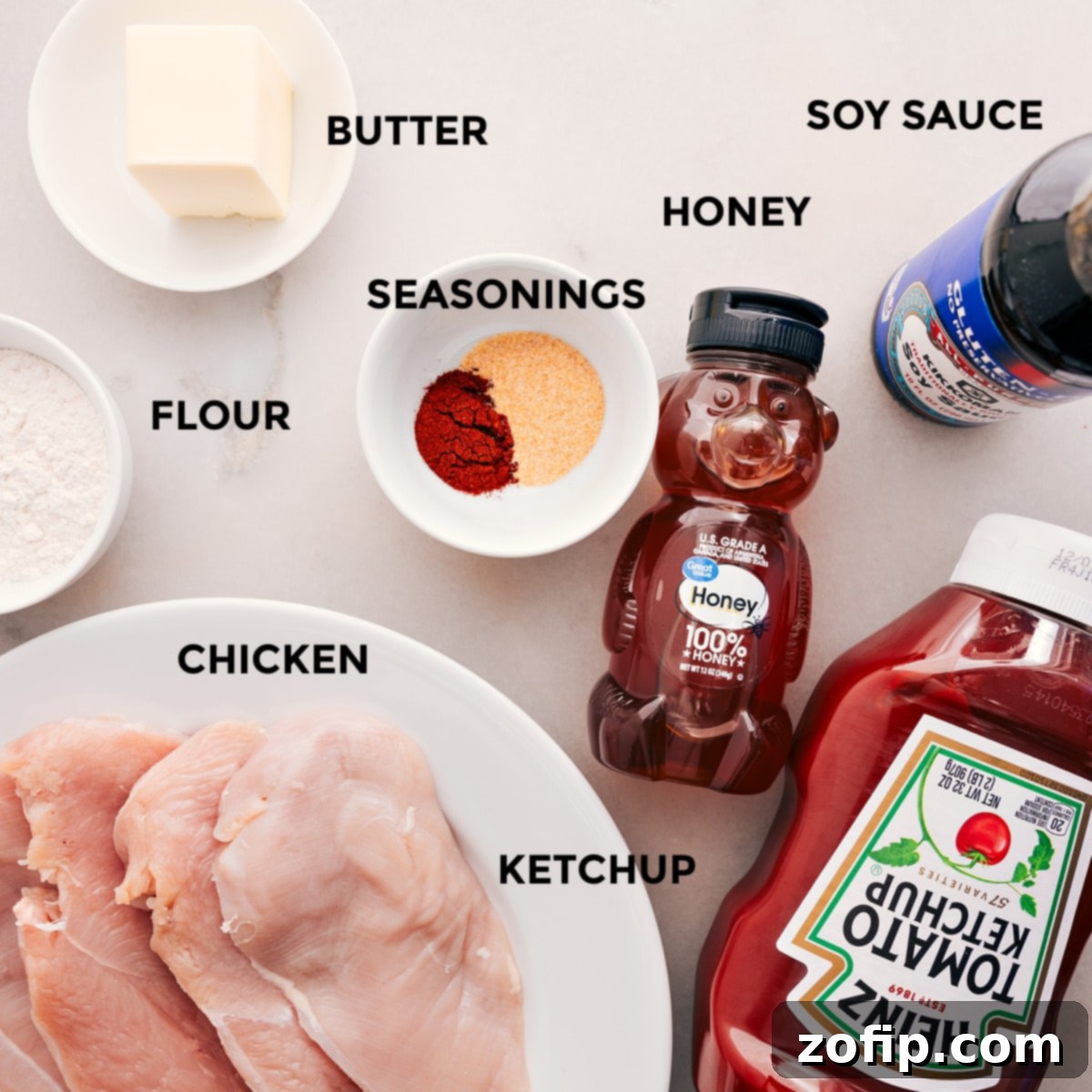 All the ingredients for this recipe are prepped and ready for easy assembly: butter, soy sauce, honey, seasonings, ketchup, meat, and flour.