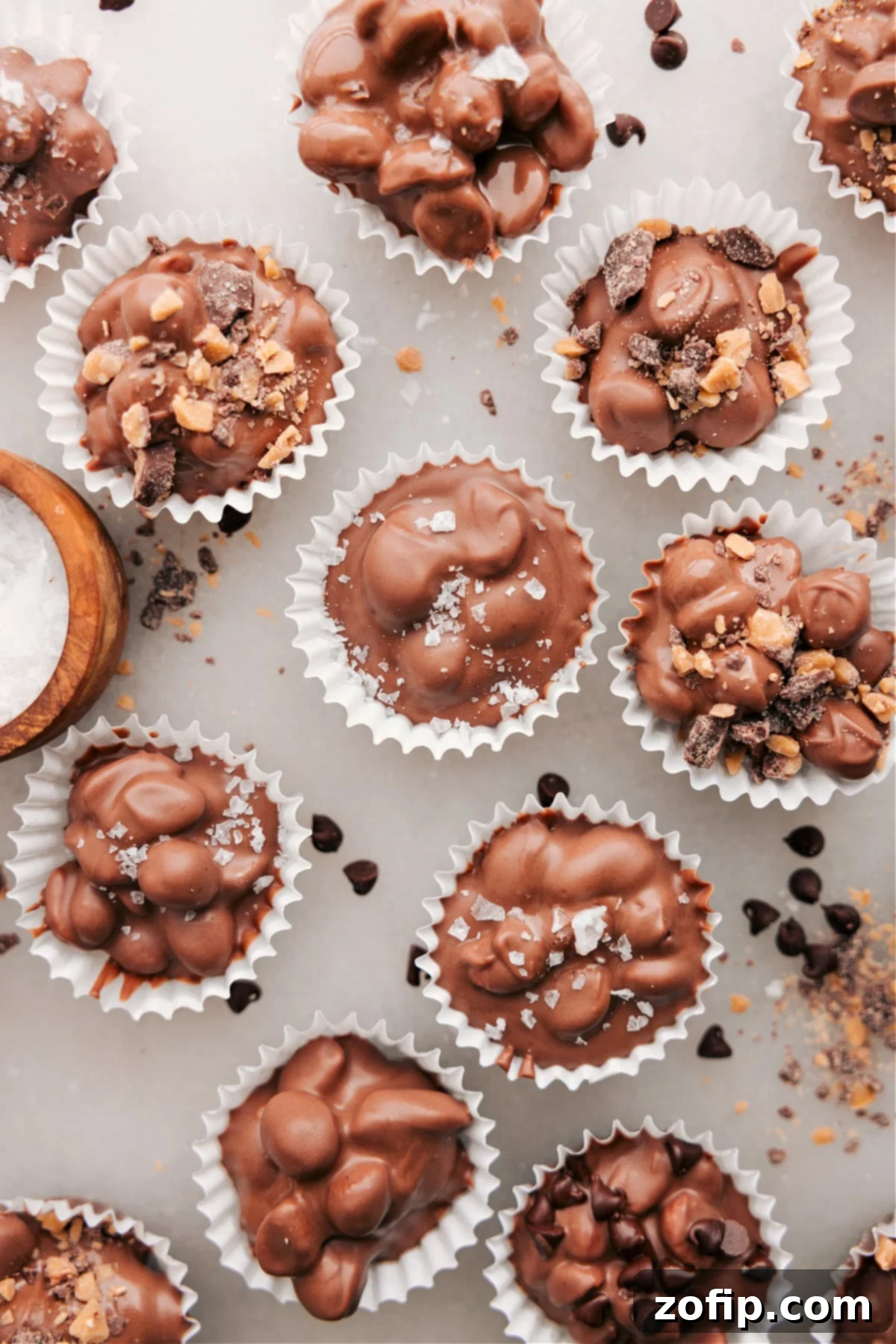 Top Crockpot Candy With Toffee Bits And Flaky Sea Salt Crockpot Candy clusters adorned with both toffee bits and flaky sea salt for enhanced flavor and texture.