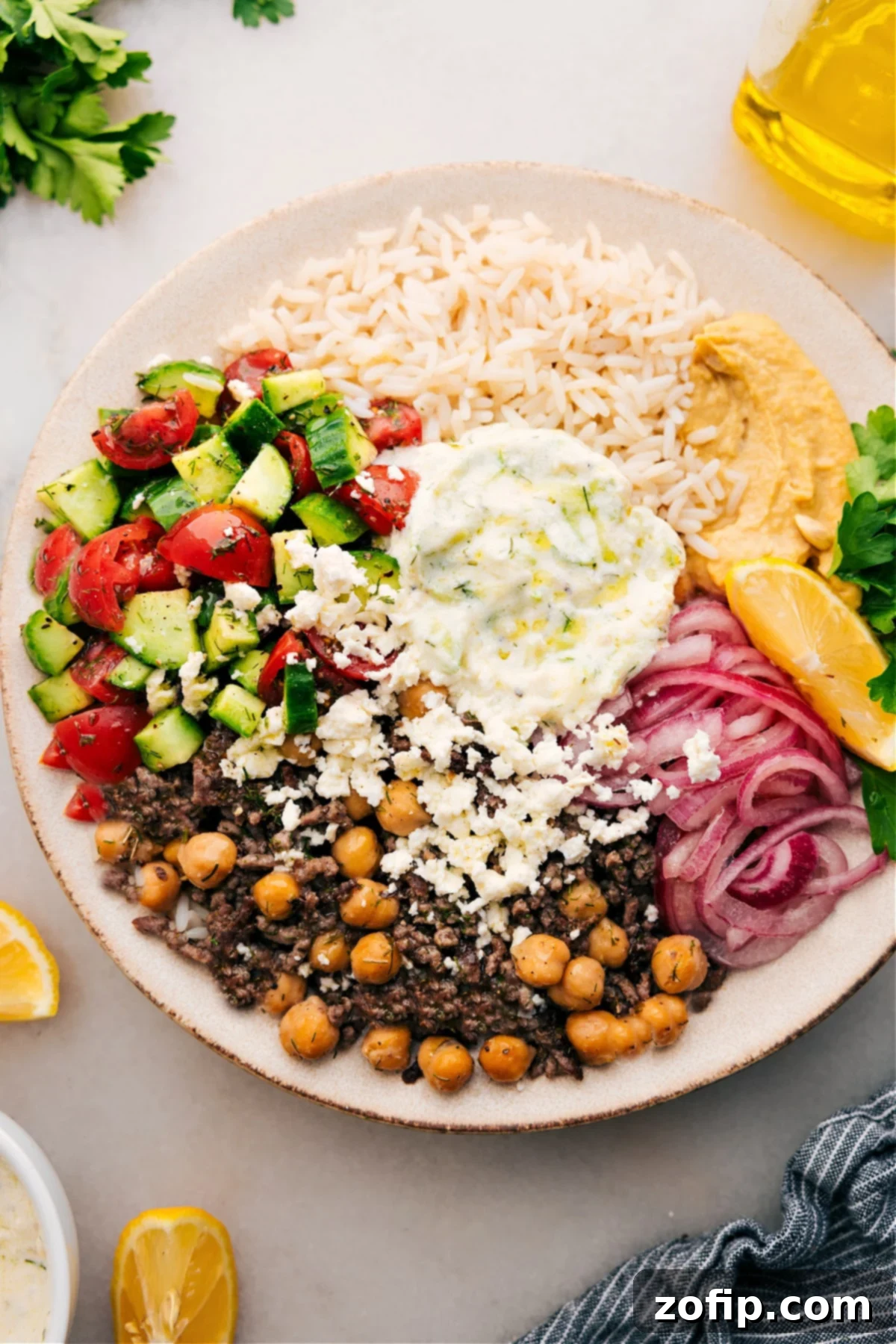 A beautifully assembled Greek Beef Bowl, featuring all components arranged for a satisfying and healthy meal.
