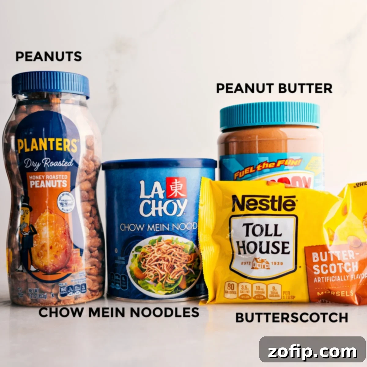 The 4 ingredients in this recipe are prepped for easy assembly: peanuts, chow mein noodles, butterscotch, and peanut butter.