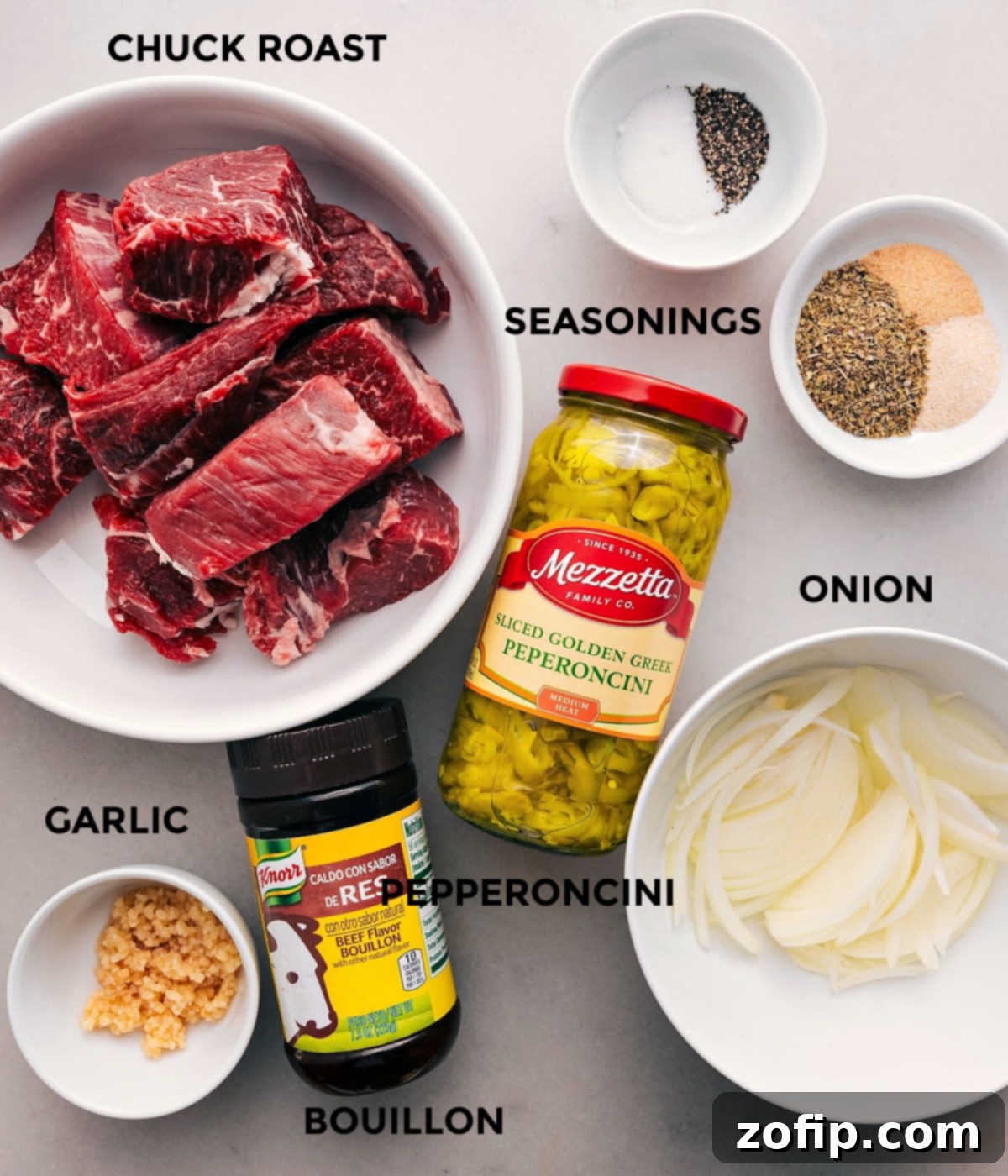 All the ingredients in this recipe are prepped for easy assembly, including the meat, pepperoncini, onion, seasonings, garlic, and bouillon.