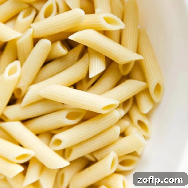 Crimson and Cream Pasta 2 Cooked penne noodles prepared and ready to be combined with the flavorful sauce.