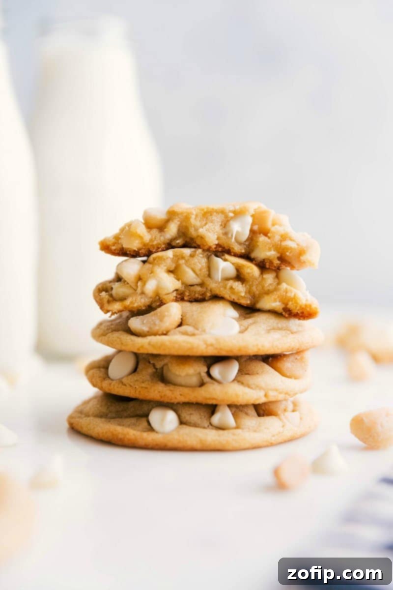White Chocolate Macadamia Nut Cookies stacked with one broken in half.