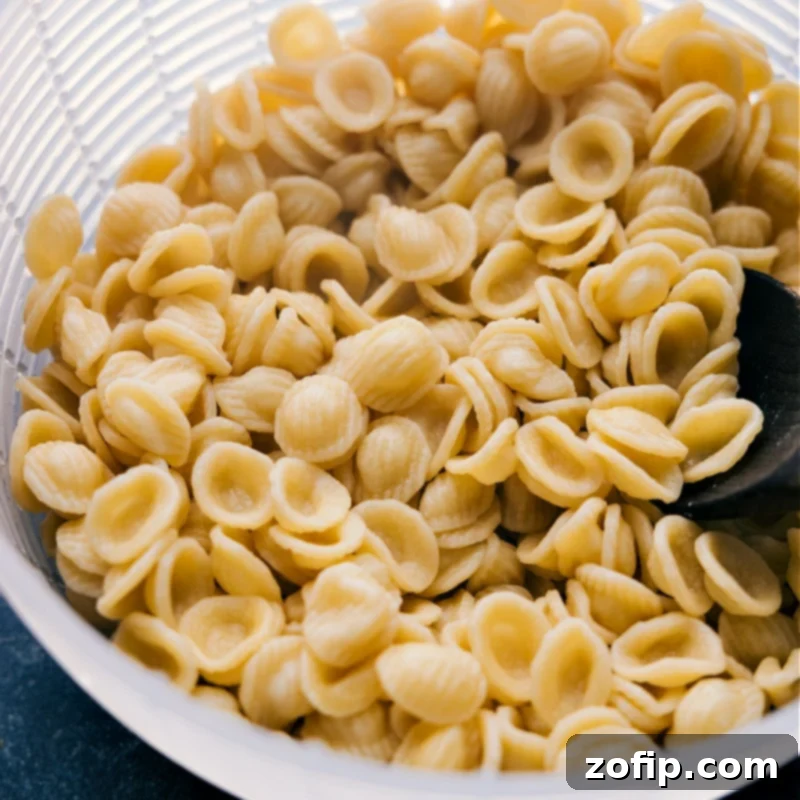 Italian Sausage and Broccoli Pasta 4 Process shots showing perfectly cooked orecchiette pasta, ready to be tossed with the flavorful sausage and broccoli sauce, highlighting its unique shape.